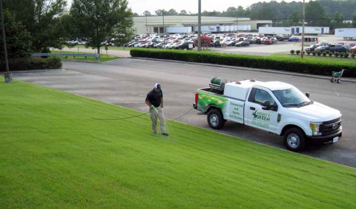 Truck on the side of a well kept commercial Sports Turf Grass